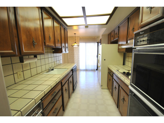 555 Palm Avenue, Unit 207 Millbrae, CA 94030 - Photo 11 of 21 a bathroom with a sink a stove and a refrigerator