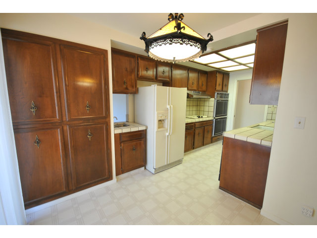 555 Palm Avenue, Unit 207 Millbrae, CA 94030 - Photo 12 of 21 a kitchen with granite countertop cabinets and stainless steel appliances