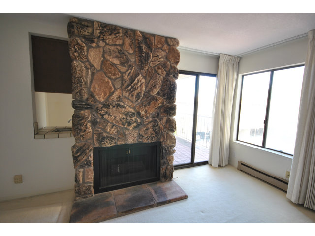 555 Palm Avenue, Unit 207 Millbrae, CA 94030 - Photo 9 of 21 a living room with a fireplace and a window