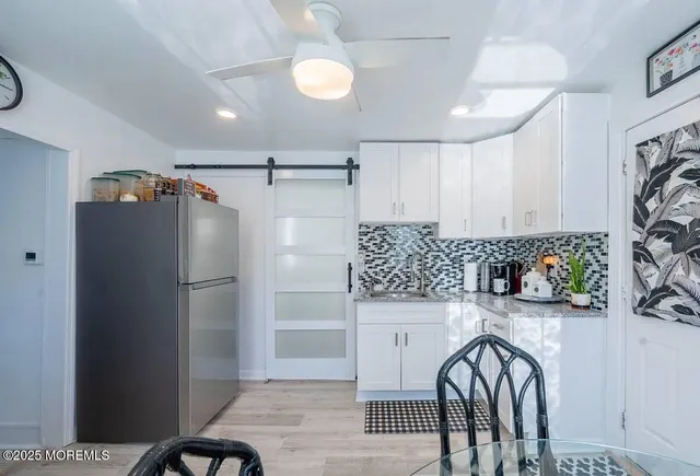 a kitchen with stainless steel appliances a refrigerator and a stove top oven