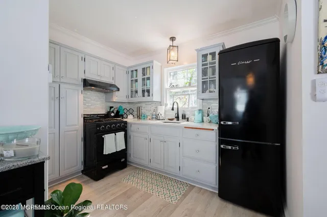 a kitchen with a refrigerator and a stove