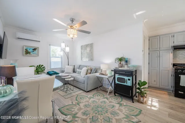a living room with furniture a fireplace and a chandelier