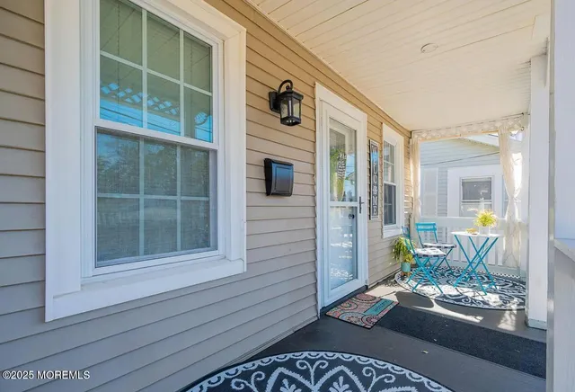 a front view of a house with outdoor seating