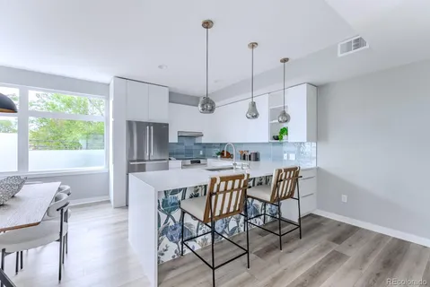 a kitchen with a sink appliances and cabinets