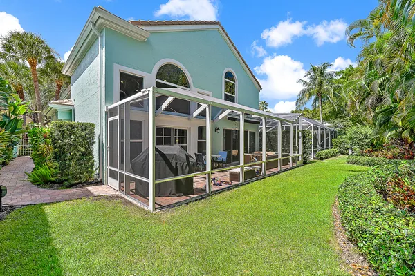 a view of a house with backyard and porch