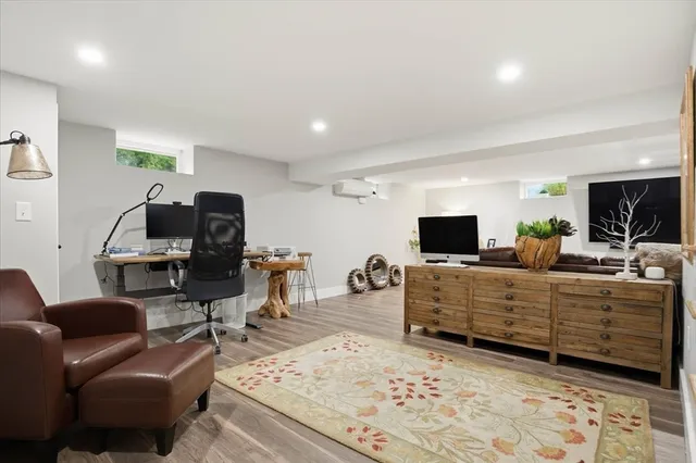 a living room with furniture a flat screen tv and kitchen view