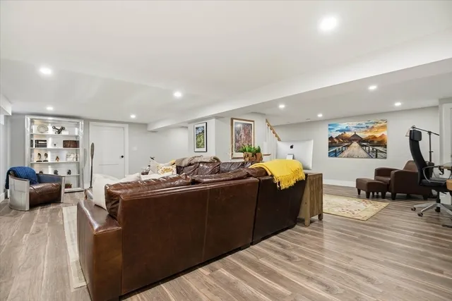 a living room with furniture a dining table and wooden floor