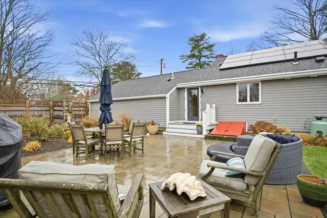 a view of a patio with couches table and chairs and potted plants