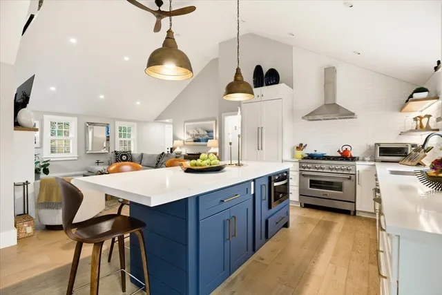 a kitchen with cabinets and chairs