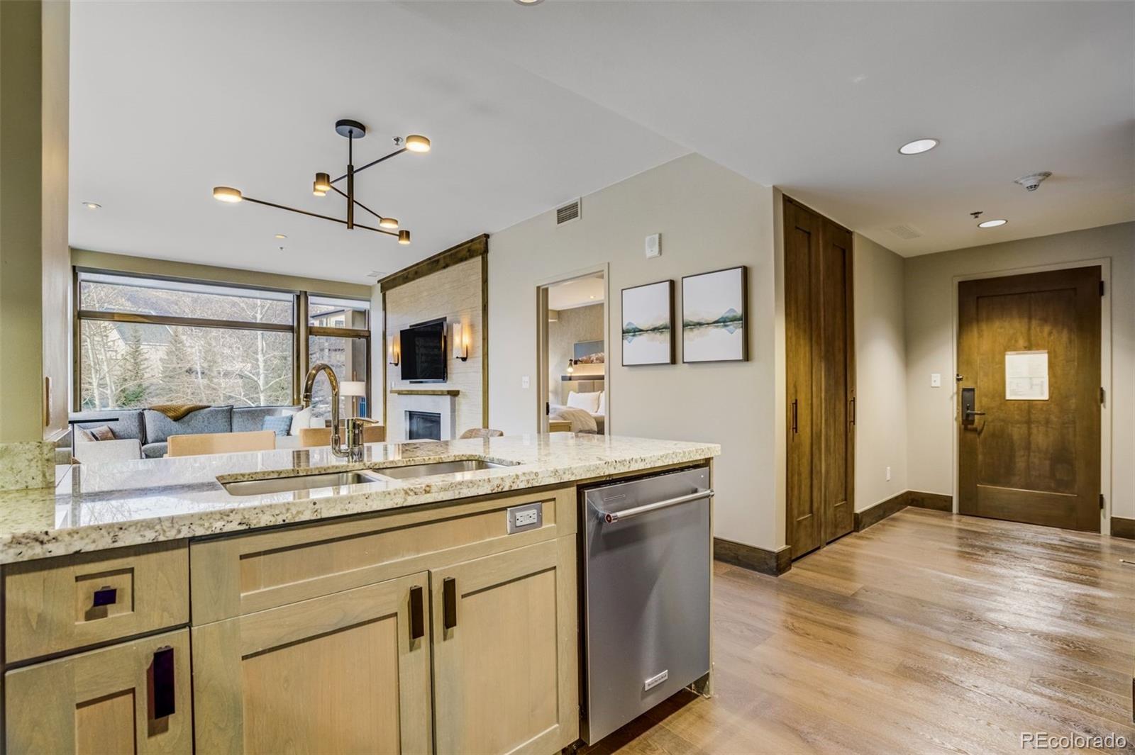 126 Riverfront Lane, Unit 200 Avon, CO 81620 - Photo 11 of 49 a kitchen with granite countertop a sink and cabinets