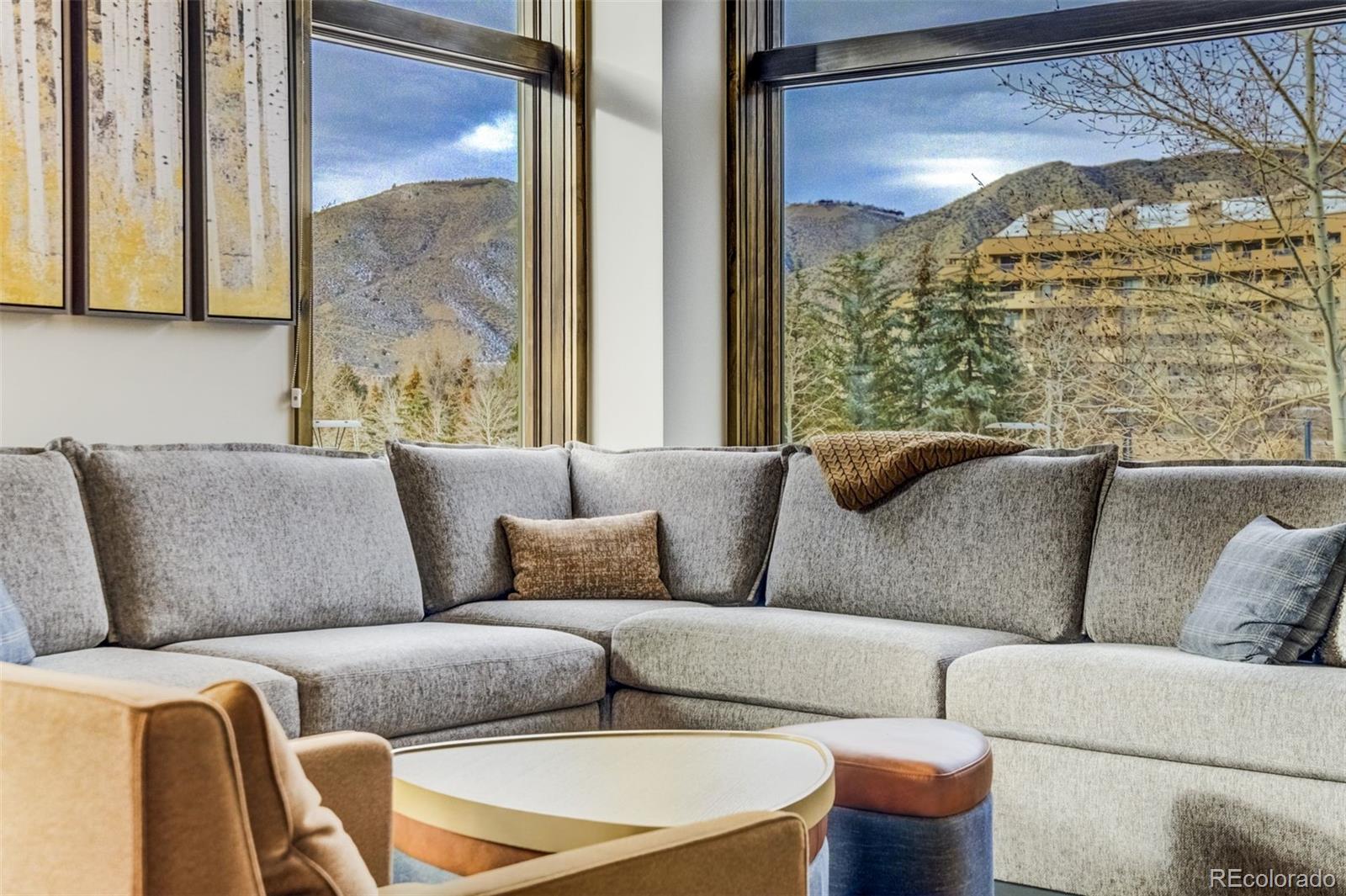 126 Riverfront Lane, Unit 200 Avon, CO 81620 - Photo 14 of 49 a living room with furniture and a large window