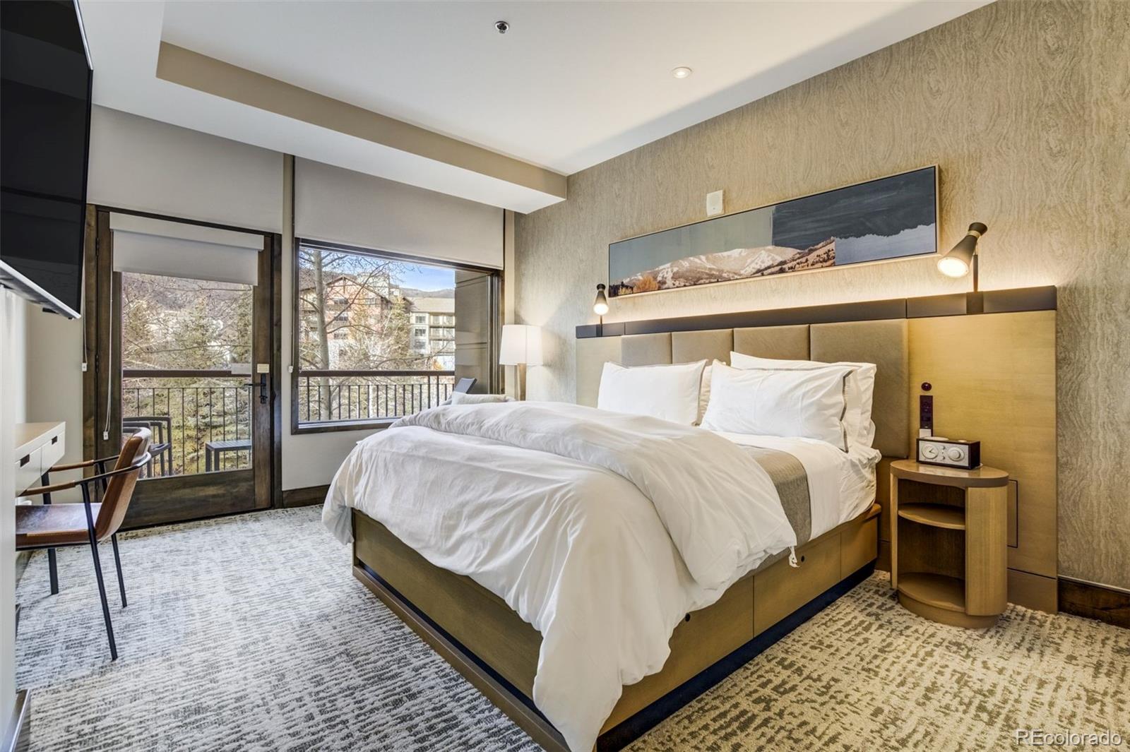 126 Riverfront Lane, Unit 200 Avon, CO 81620 - Photo 20 of 49 a bedroom with a bed chair and double door