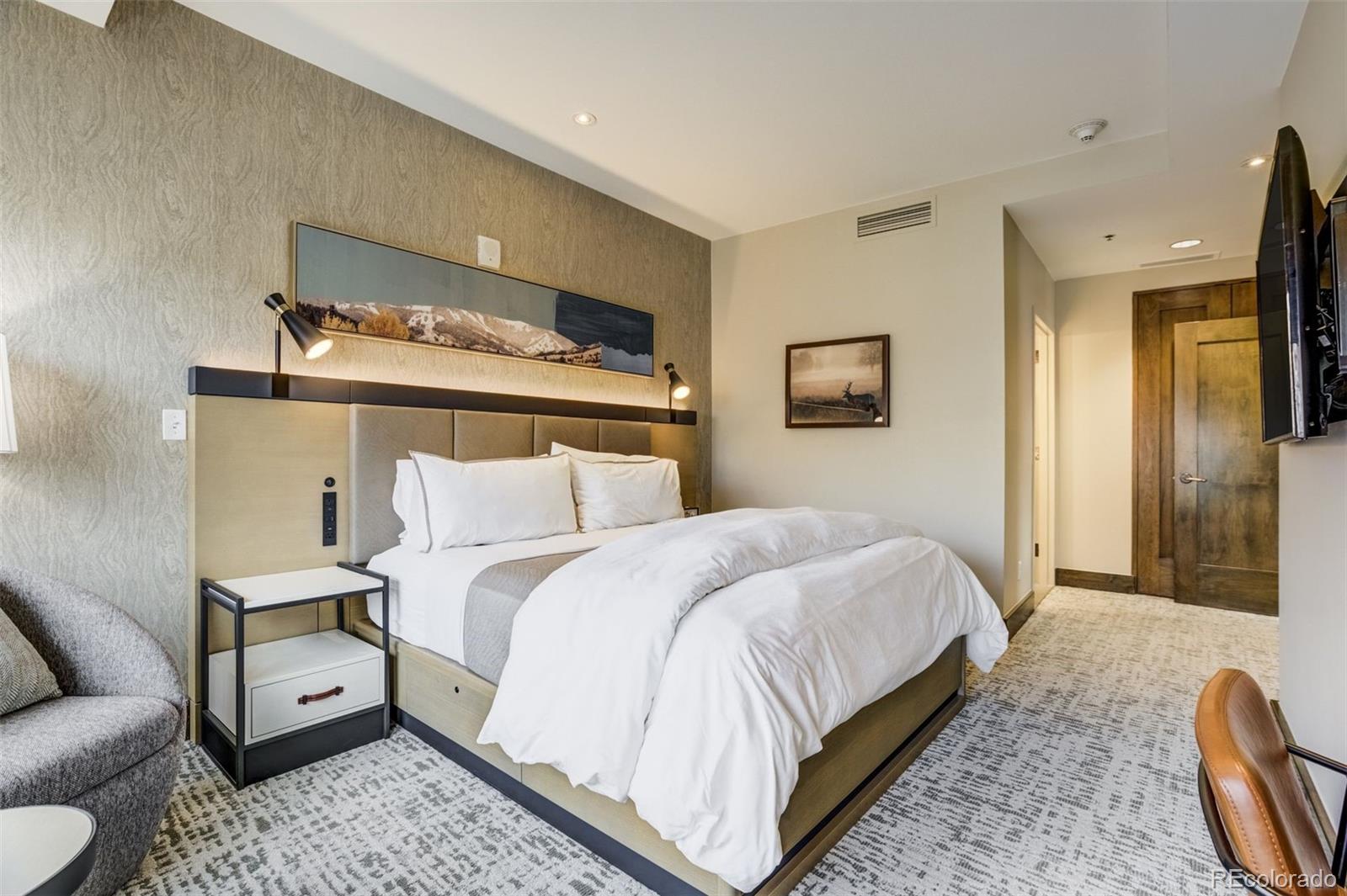 126 Riverfront Lane, Unit 200 Avon, CO 81620 - Photo 22 of 49 a bedroom with bed and wooden floor