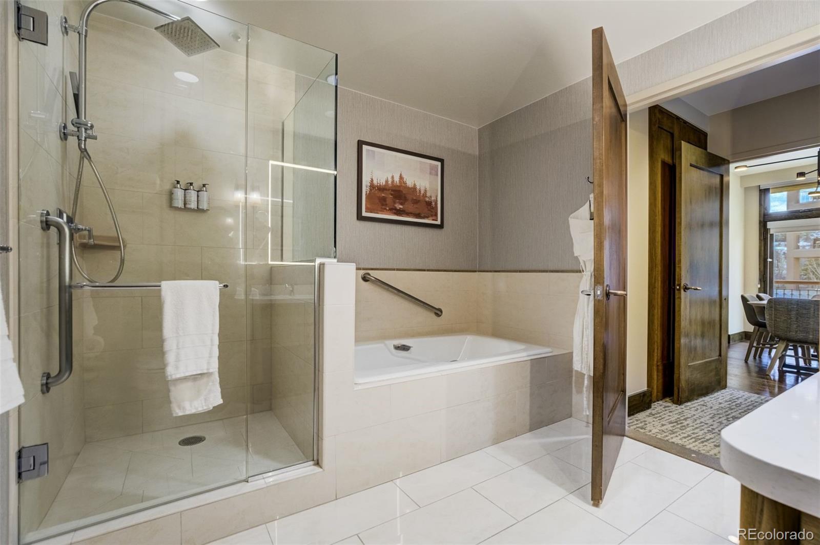 126 Riverfront Lane, Unit 200 Avon, CO 81620 - Photo 25 of 49 a bathroom with a bathtub and a shower