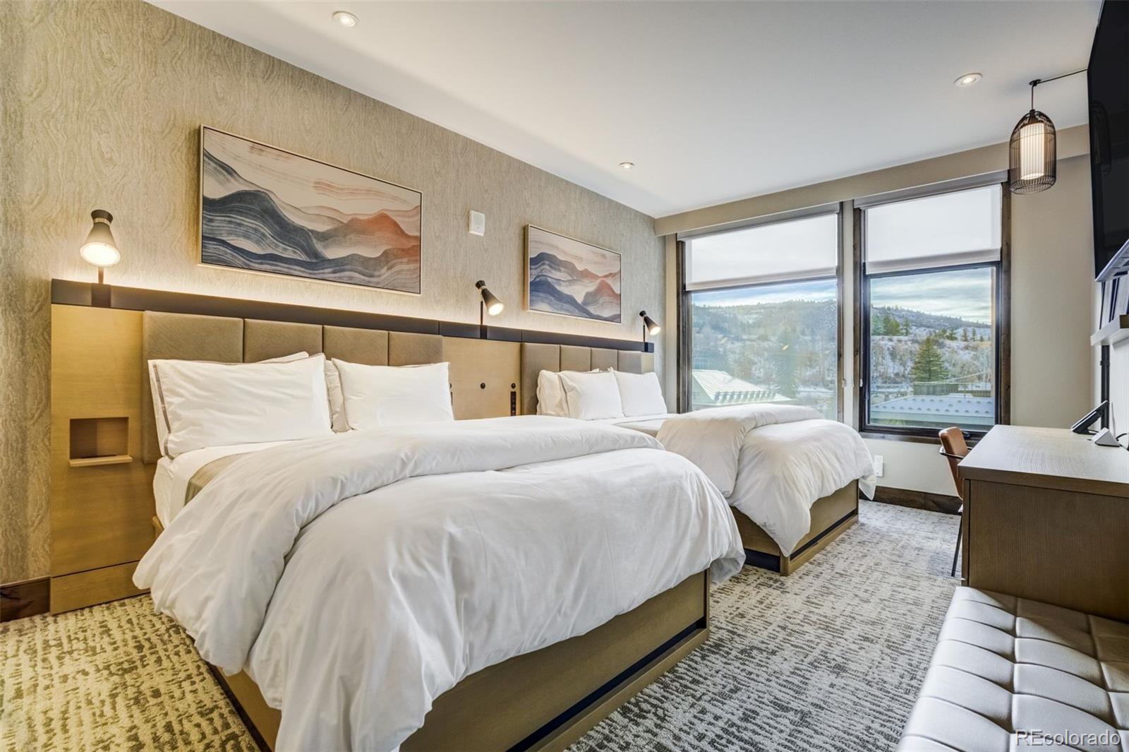 126 Riverfront Lane, Unit 200 Avon, CO 81620 - Photo 28 of 49 a bedroom with bed and a large window