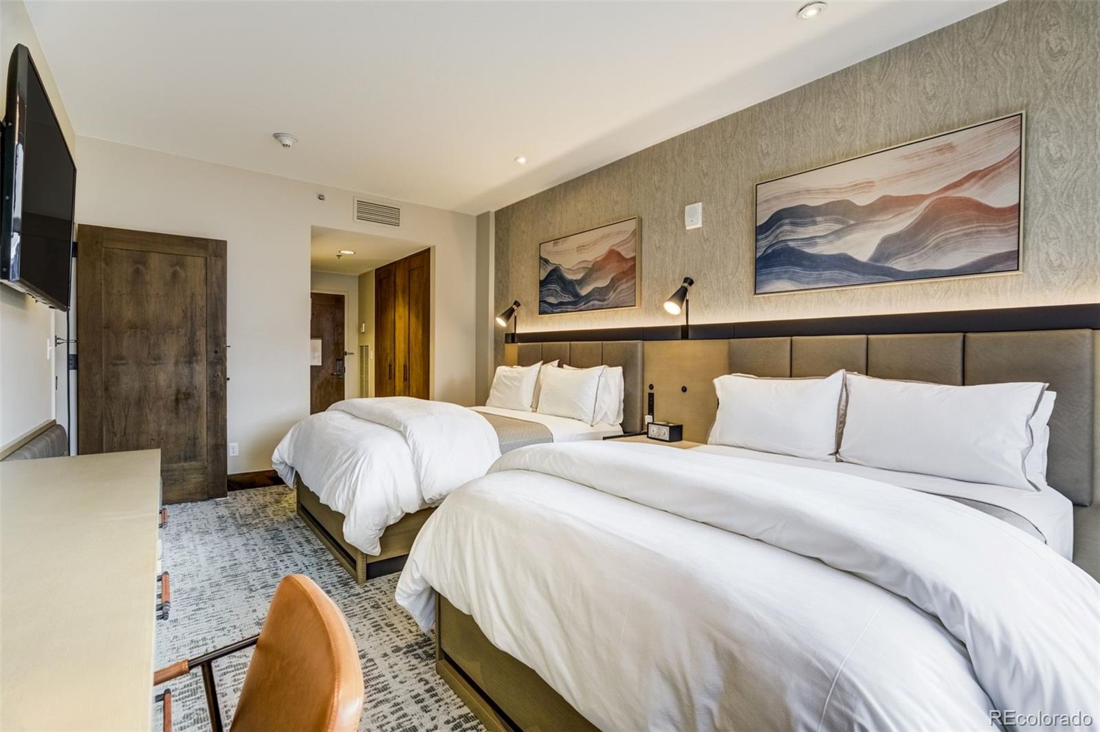 126 Riverfront Lane, Unit 200 Avon, CO 81620 - Photo 31 of 49 a bedroom with a bed a painting and wall painting