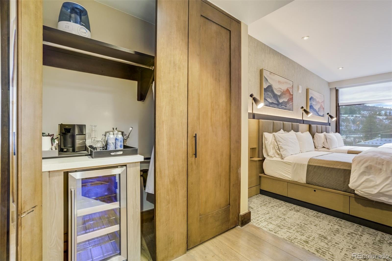 126 Riverfront Lane, Unit 200 Avon, CO 81620 - Photo 34 of 49 a bedroom with a bed and a painting on the wall