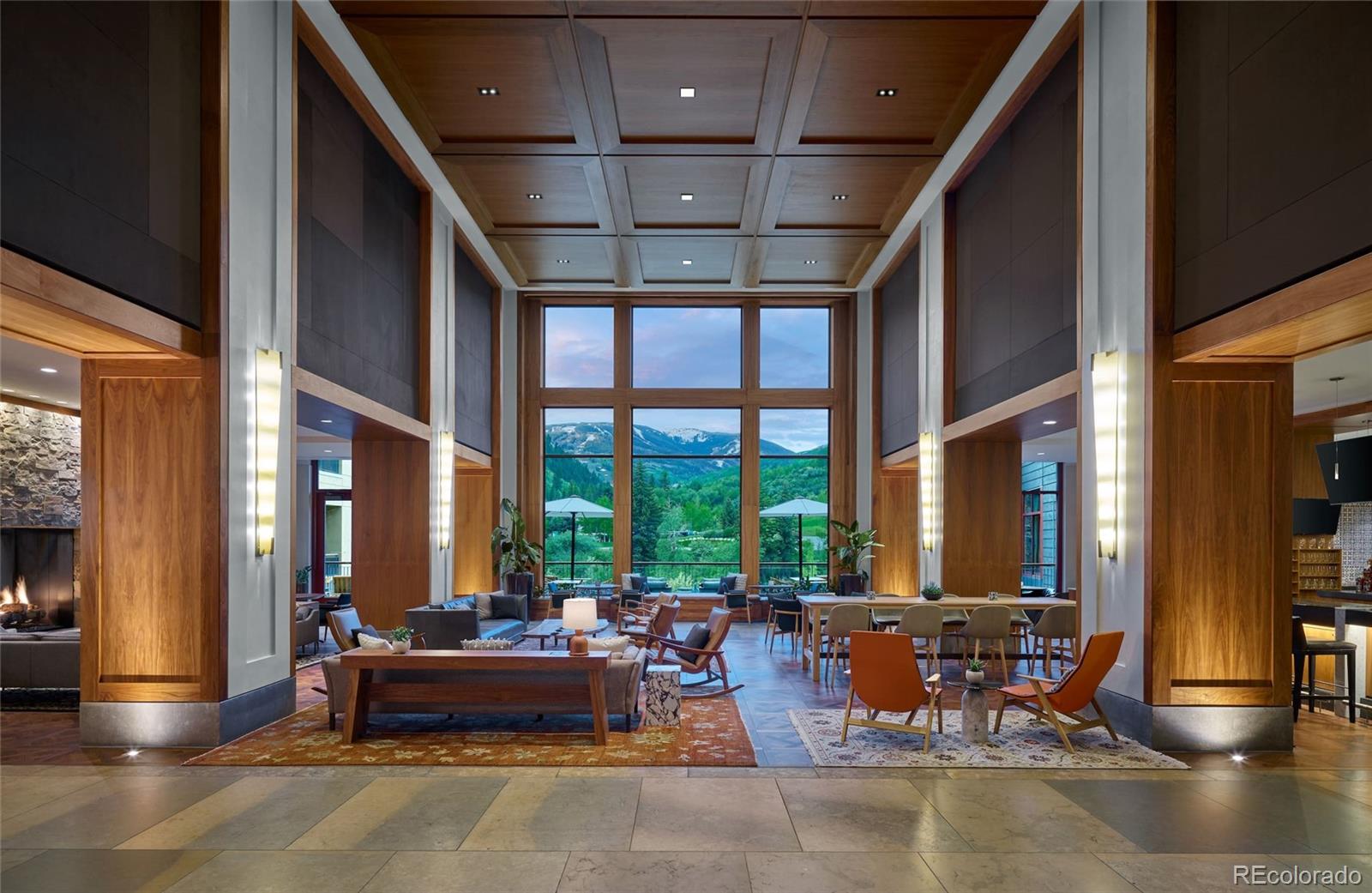 126 Riverfront Lane, Unit 200 Avon, CO 81620 - Photo 35 of 49 a living room with furniture and floor to ceiling windows