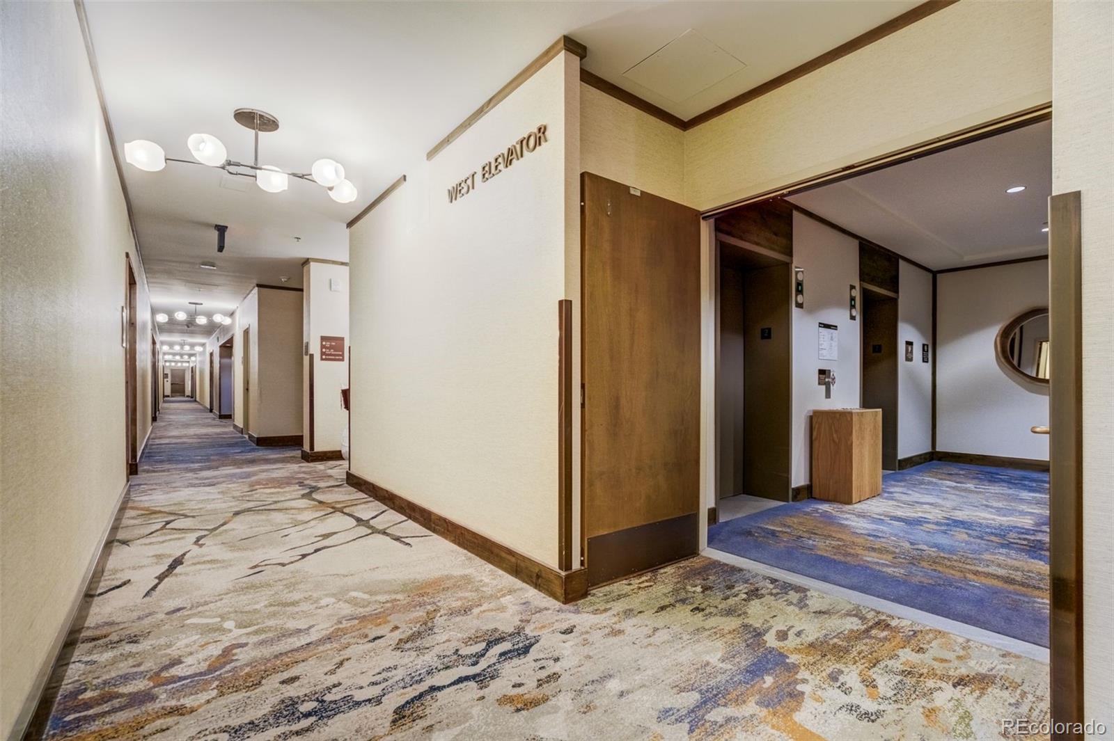 126 Riverfront Lane, Unit 200 Avon, CO 81620 - Photo 5 of 49 a view of a hallway with wooden floor