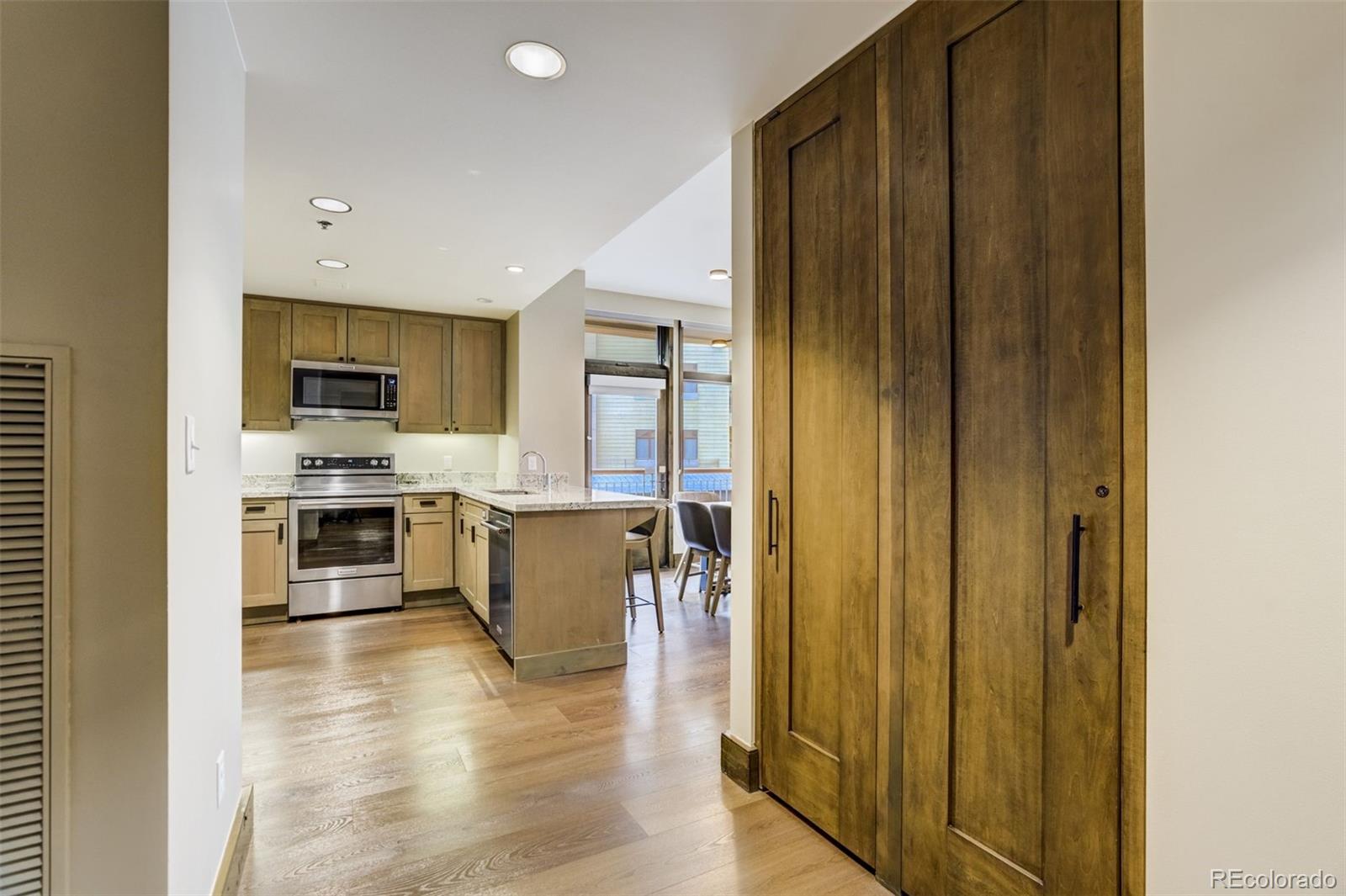 126 Riverfront Lane, Unit 200 Avon, CO 81620 - Photo 8 of 49 a kitchen with stainless steel appliances granite countertop a refrigerator and a stove top oven