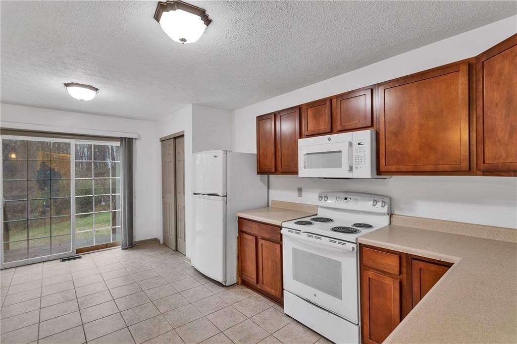 188 Congruity Road Greensburg, PA 15601 - Photo 23 of 50 a kitchen with stainless steel appliances a stove sink and cabinets
