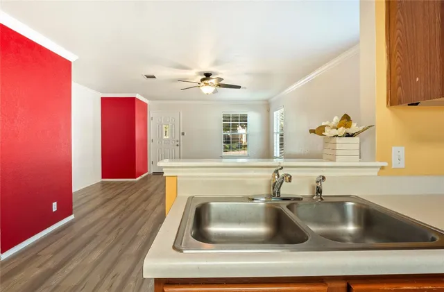 a kitchen with sink a faucet and chairs