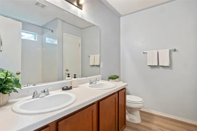 a bathroom with a toilet sink and mirror