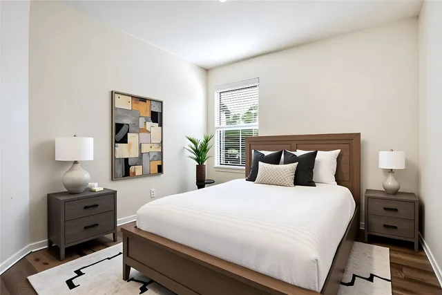 a bedroom with a bed and a night stand