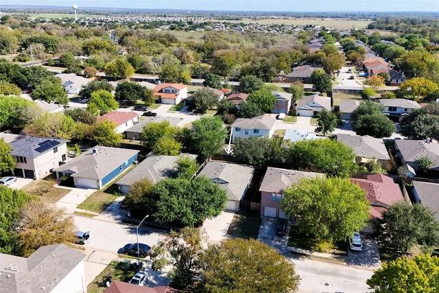 an aerial view of a houses with a swimming pool