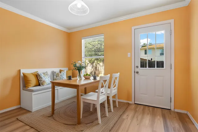 a dining room with furniture and wooden floor
