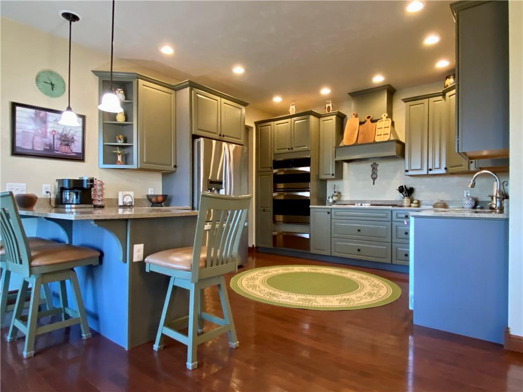 440 Wilson Road Worthington, PA 16262 - Photo 8 of 48 a kitchen with kitchen island granite countertop wooden floors and a view of living room