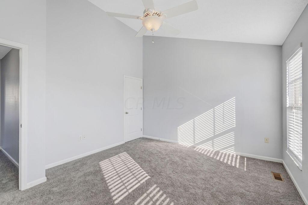 6345 Needletail Road, Unit 24634 Columbus, OH 43230 - Photo 16 of 58 • New gray carpet ~ 2021 • Gray painted walls • Vaulted ceiling • Lighted ceiling fan • 2” blinds