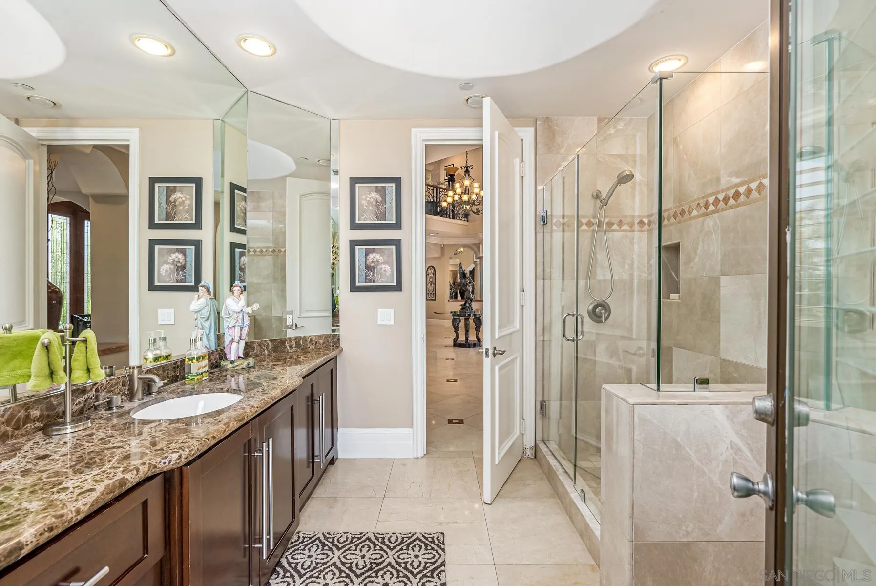 2871 Gate 3 Place Chula Vista, CA 91914 - Photo 26 of 73 a bathroom with a granite countertop sink a mirror a vanity and a shower