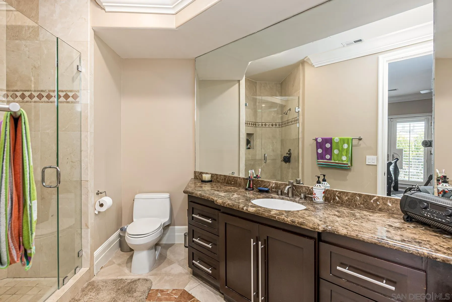 2871 Gate 3 Place Chula Vista, CA 91914 - Photo 38 of 73 a bathroom with a granite countertop sink mirror vanity and toilet