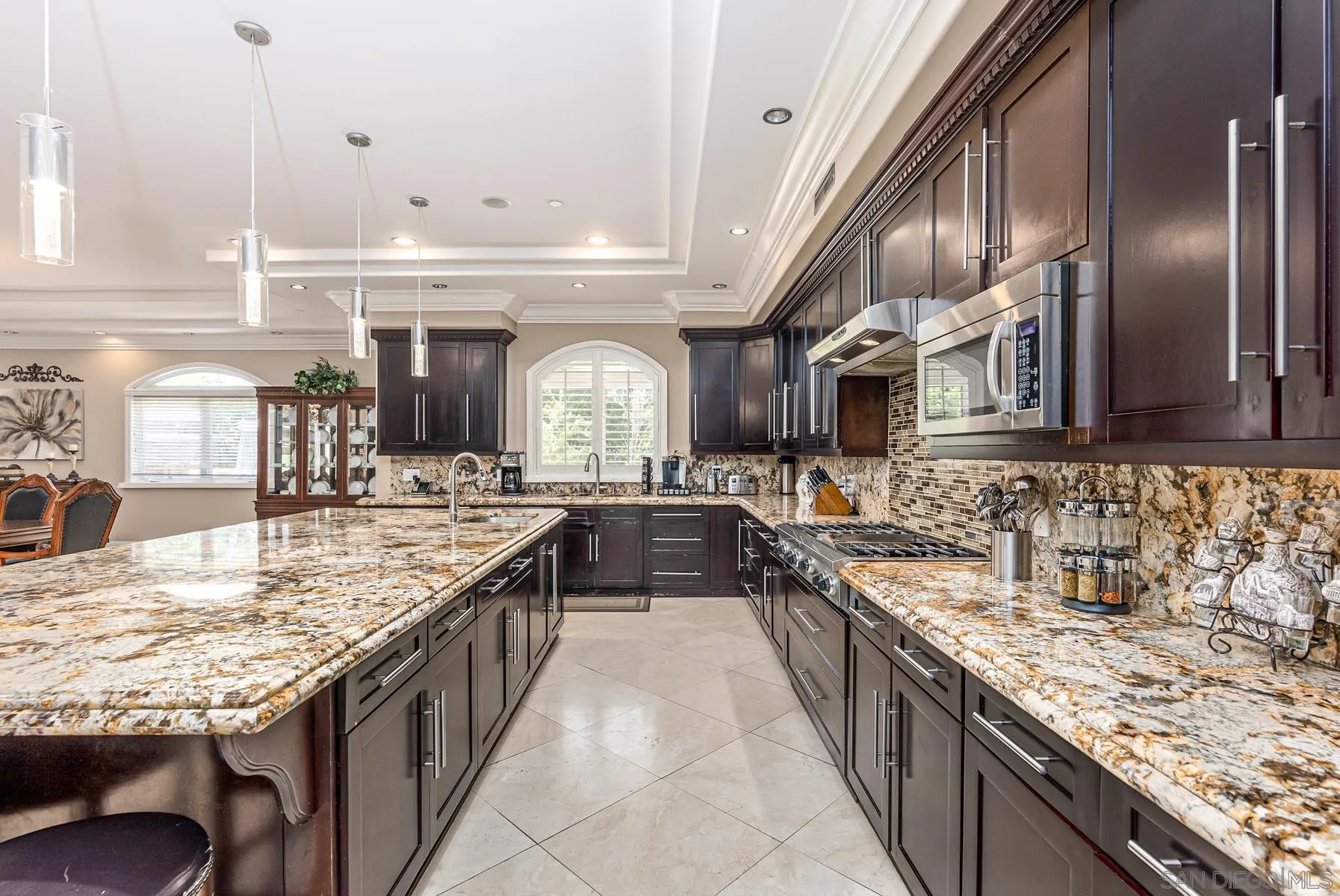 2871 Gate 3 Place Chula Vista, CA 91914 - Photo 47 of 73 a large kitchen with stainless steel appliances granite countertop a sink and counter space