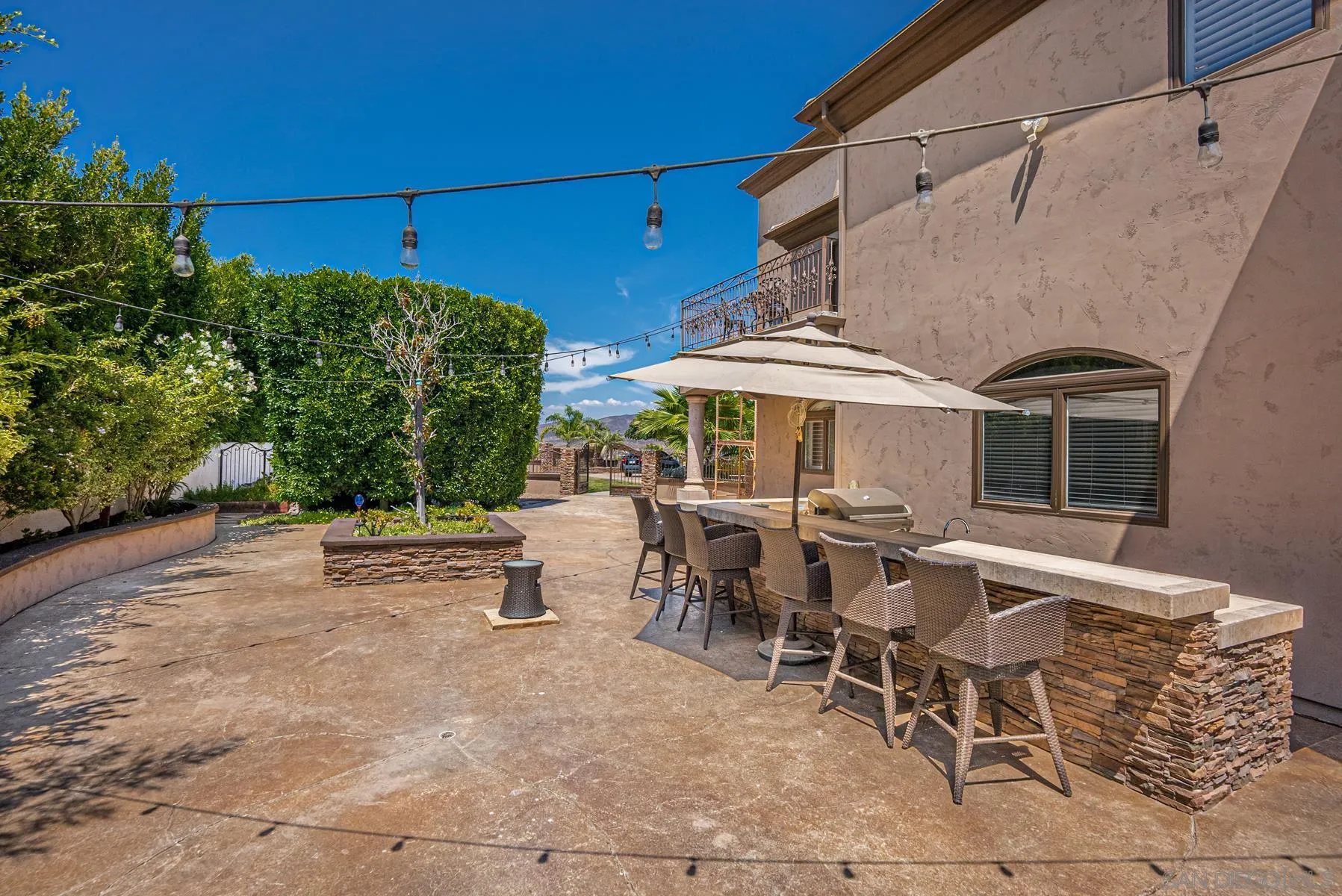 2871 Gate 3 Place Chula Vista, CA 91914 - Photo 60 of 73 a view of a patio with a table and chairs under an umbrella