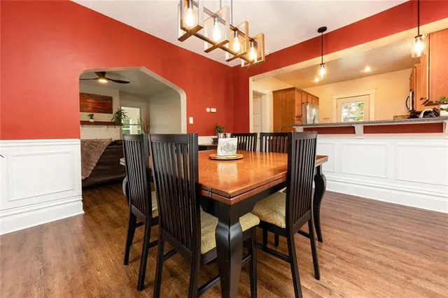 a dining room with furniture and wooden floor