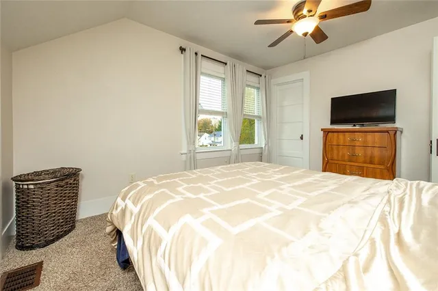 a bedroom with a bed and a television