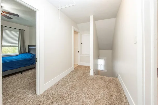 a view of an empty room and bathroom