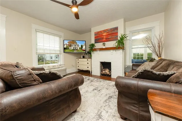 a living room with furniture a flat screen tv and a fireplace