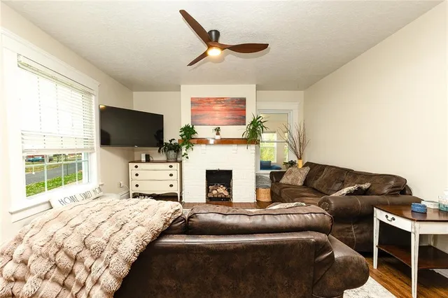 a living room with furniture a flat screen tv and a fireplace