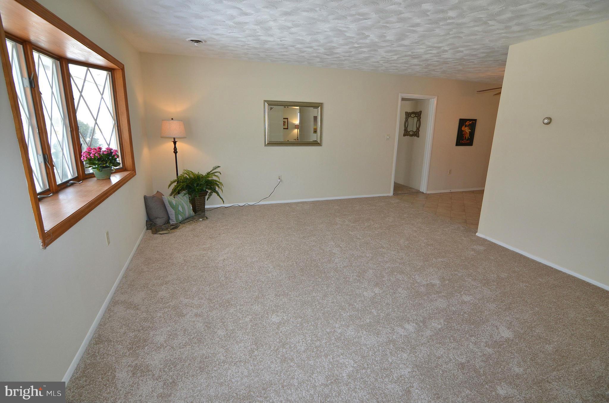 112 Thomas Road Glen Burnie, MD 21060 - Photo 2 of 30 a view of an empty room with a window and wooden floor