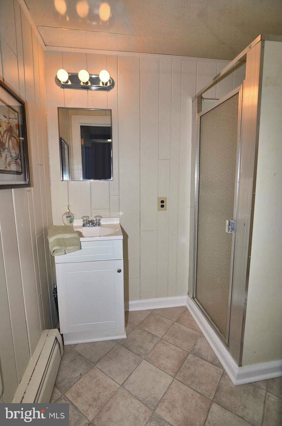 112 Thomas Road Glen Burnie, MD 21060 - Photo 17 of 30 a bathroom with a sink a mirror and vanity