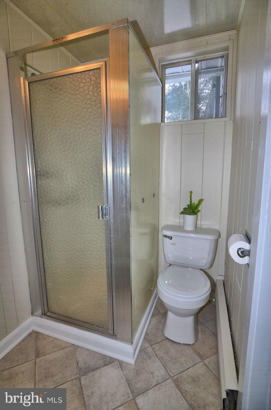 112 Thomas Road Glen Burnie, MD 21060 - Photo 18 of 30 a bathroom with a granite countertop toilet and a shower