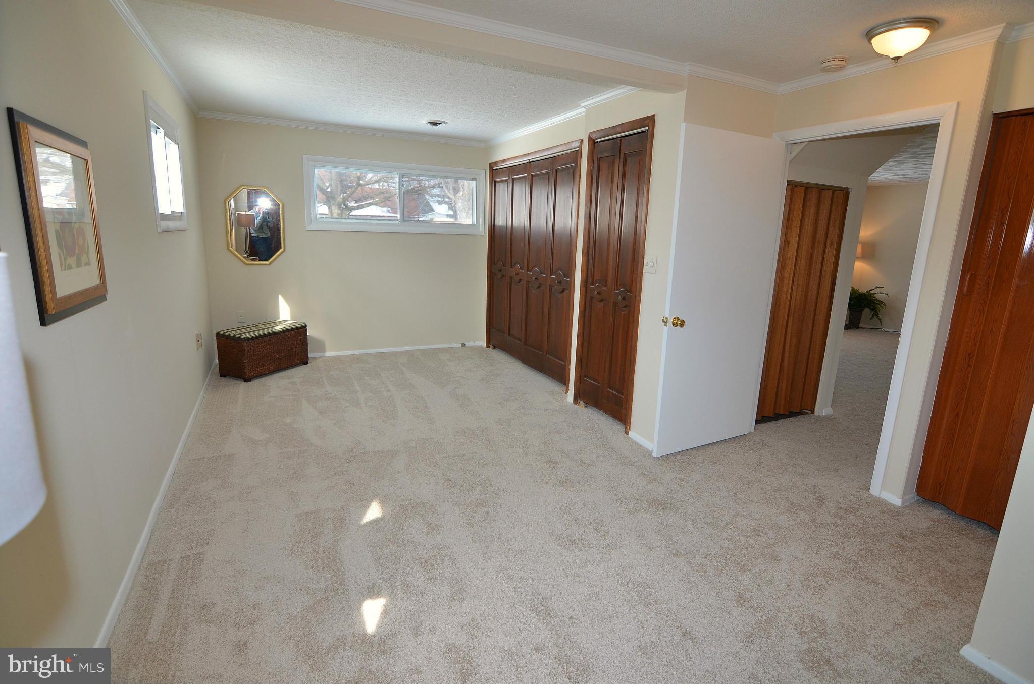 112 Thomas Road Glen Burnie, MD 21060 - Photo 23 of 30 an empty room with wooden floor and windows