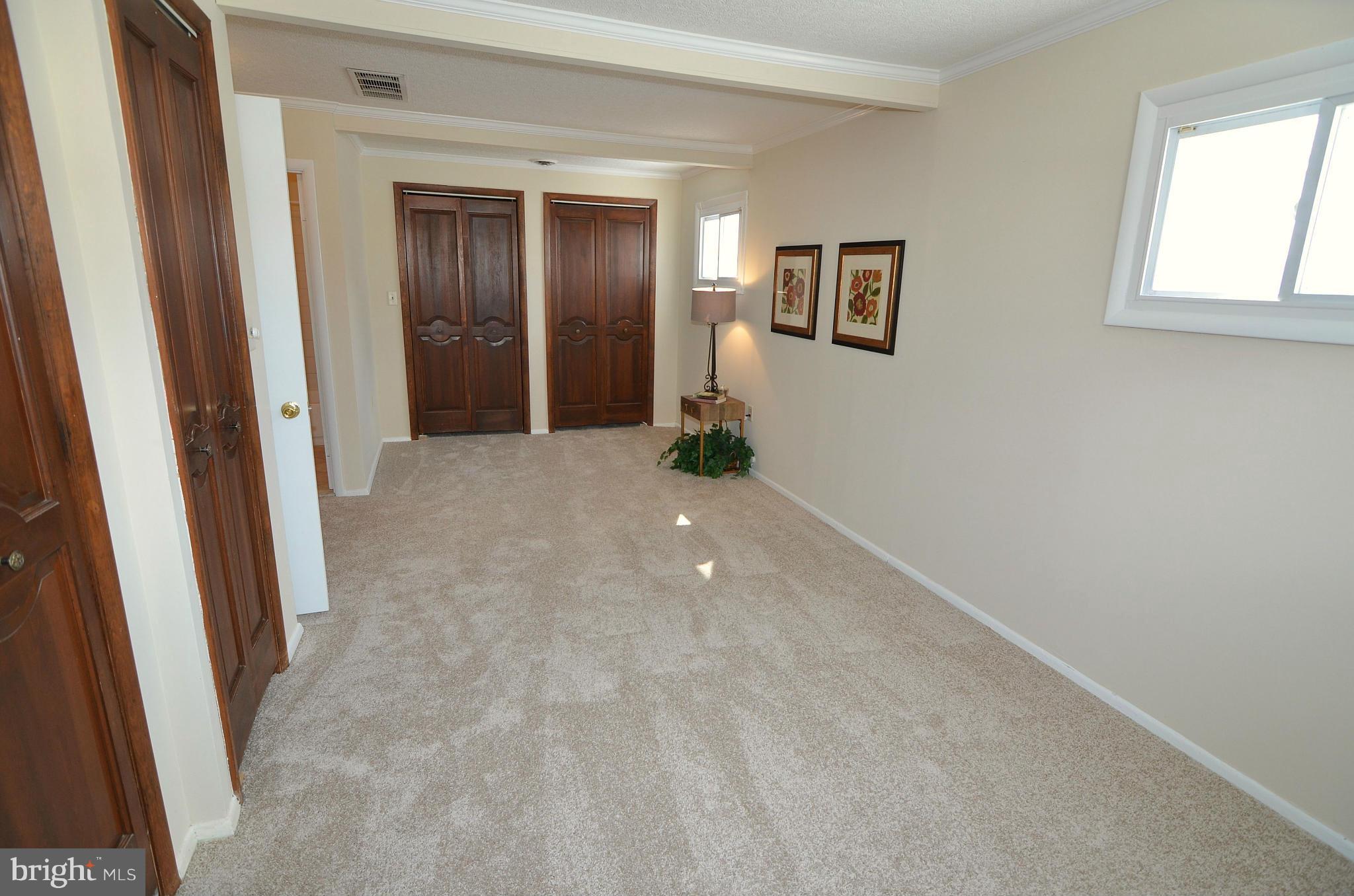 112 Thomas Road Glen Burnie, MD 21060 - Photo 25 of 30 a view of a hallway with wooden floor and windows