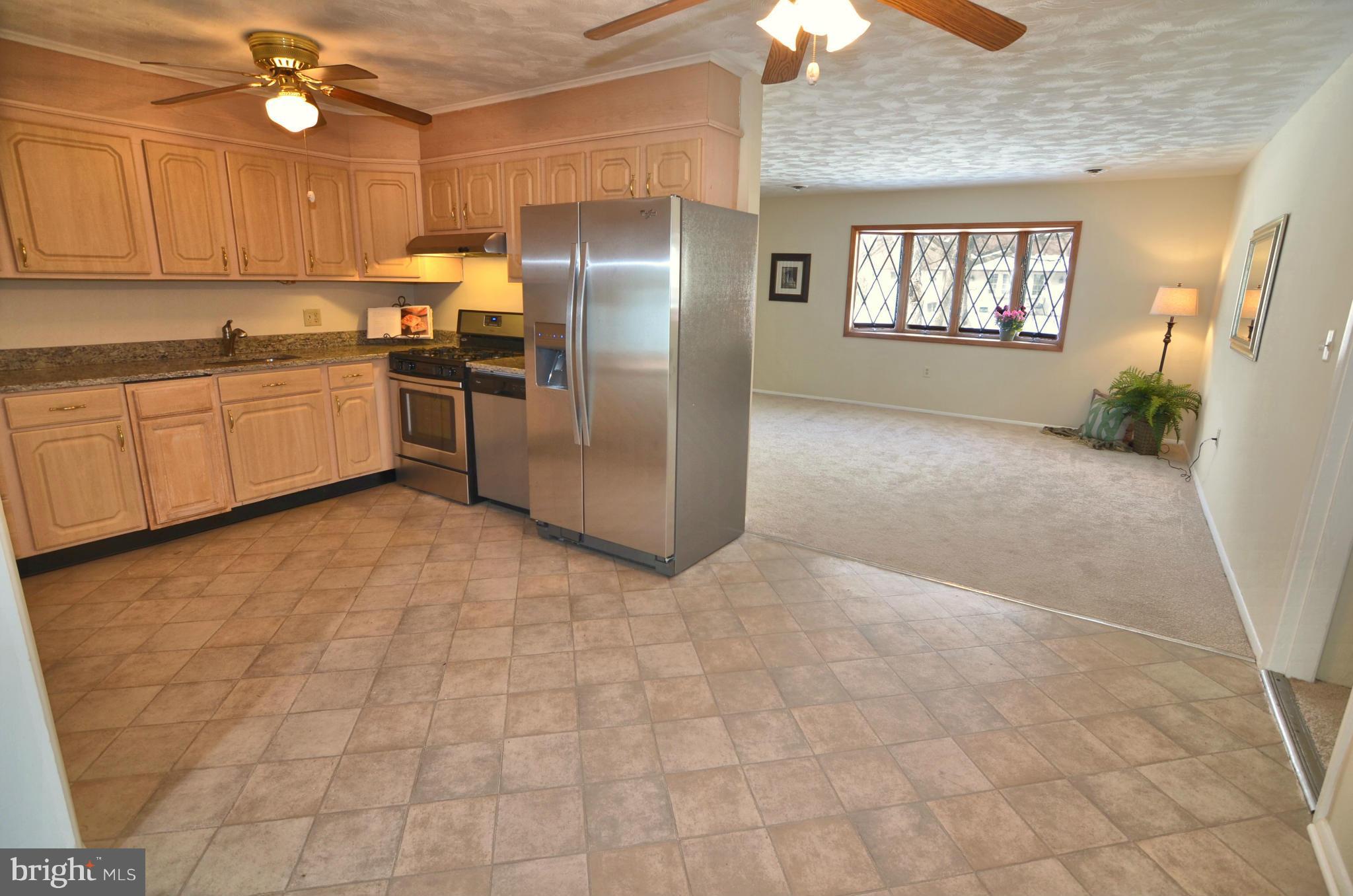 112 Thomas Road Glen Burnie, MD 21060 - Photo 7 of 30 a kitchen with stainless steel appliances a refrigerator sink and cabinets