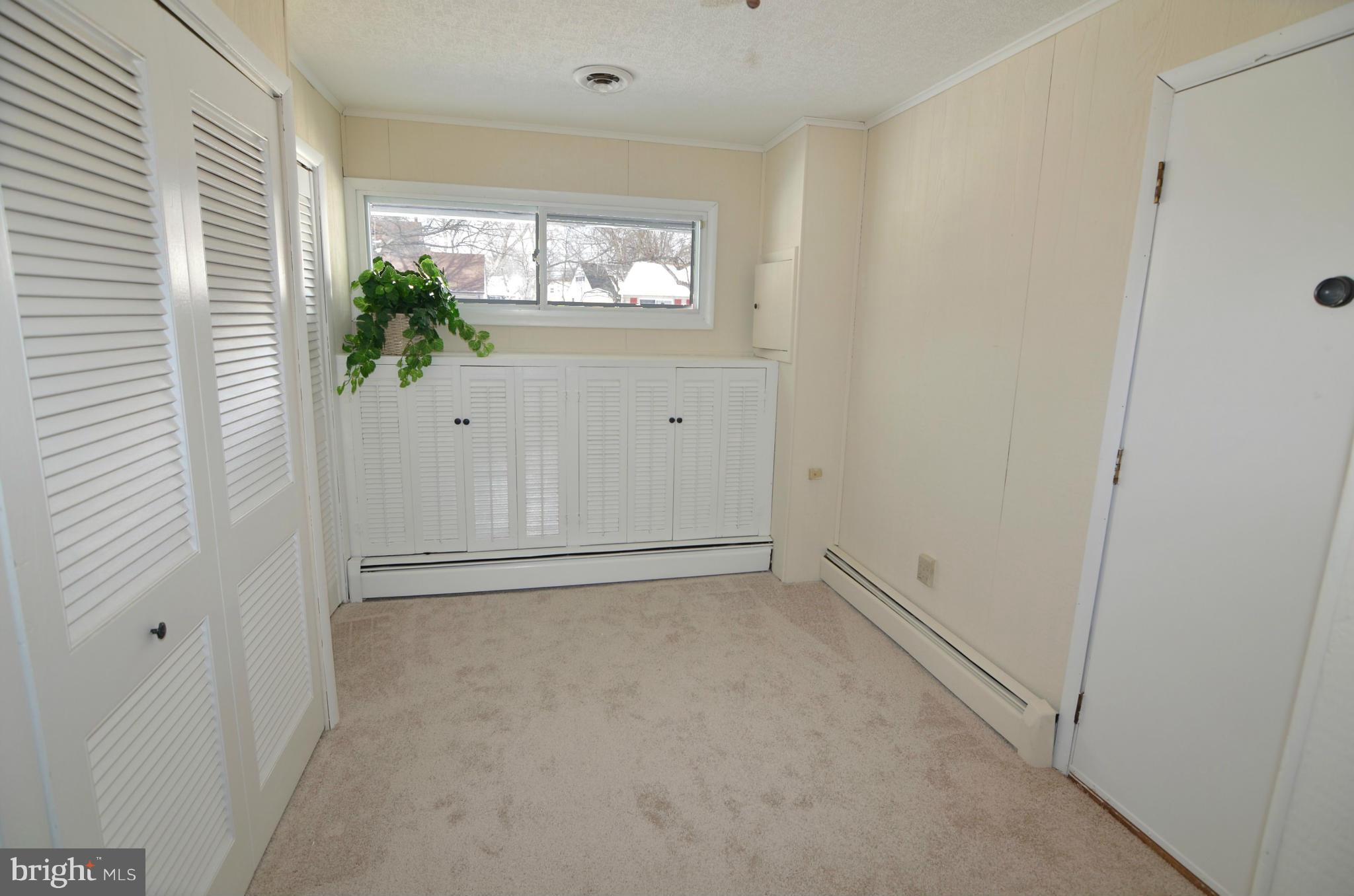 112 Thomas Road Glen Burnie, MD 21060 - Photo 8 of 30 an empty room with windows and entrance