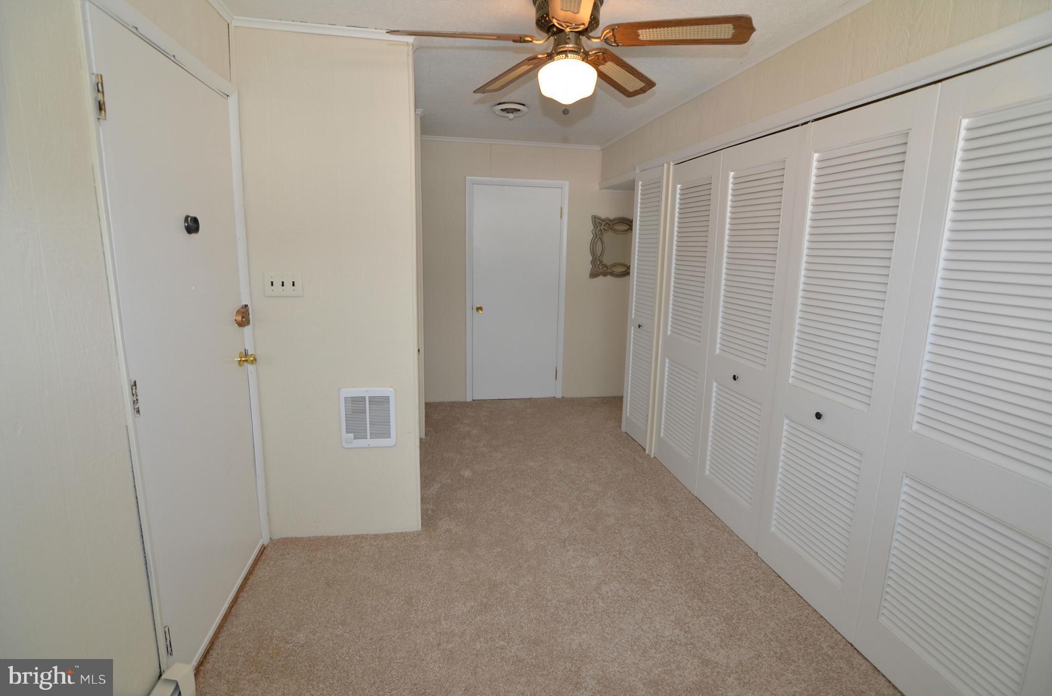 112 Thomas Road Glen Burnie, MD 21060 - Photo 10 of 30 a view of a hallway with a chandelier fan