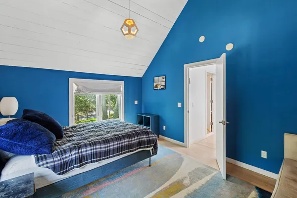 a bedroom with a bed and a potted plant